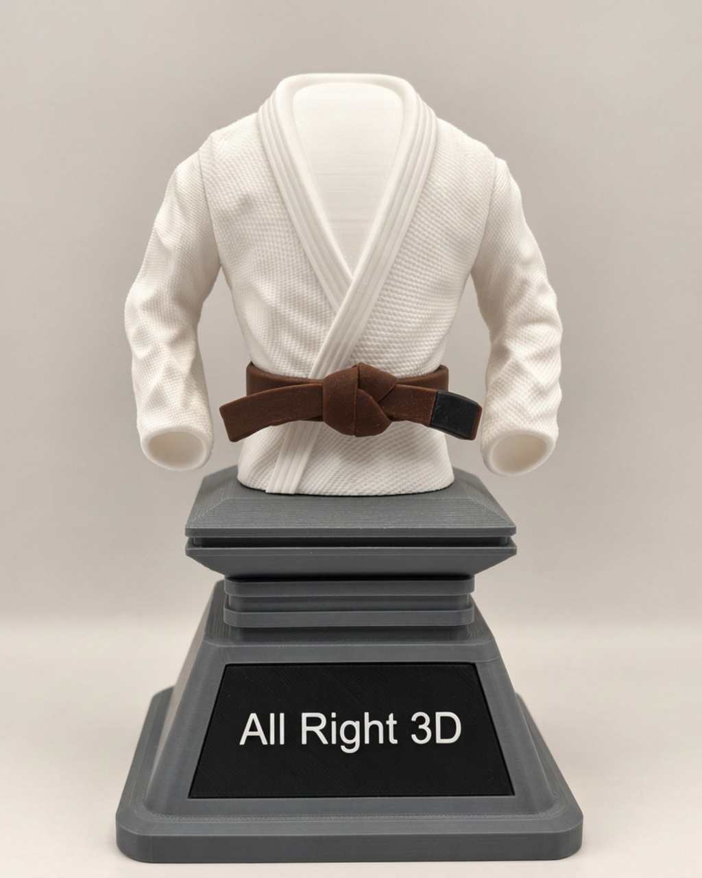 White BJJ gi trophy with brown belt front view