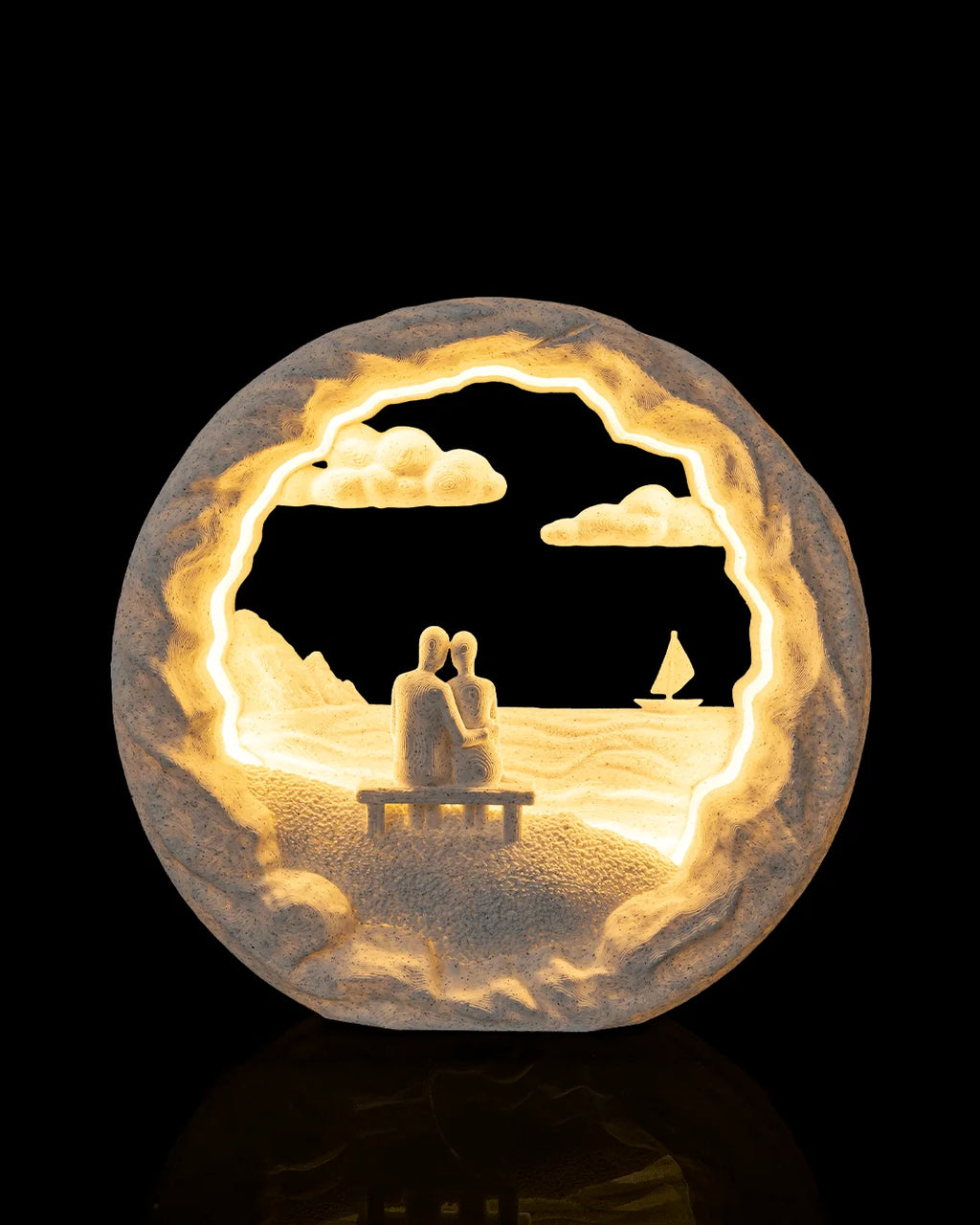 Dockside Dream Table Lamp illuminated from the front, showing two figures on a dock and a sailboat