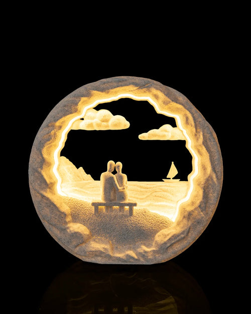 Dockside Dream Table Lamp illuminated from the front, showing two figures on a dock and a sailboat