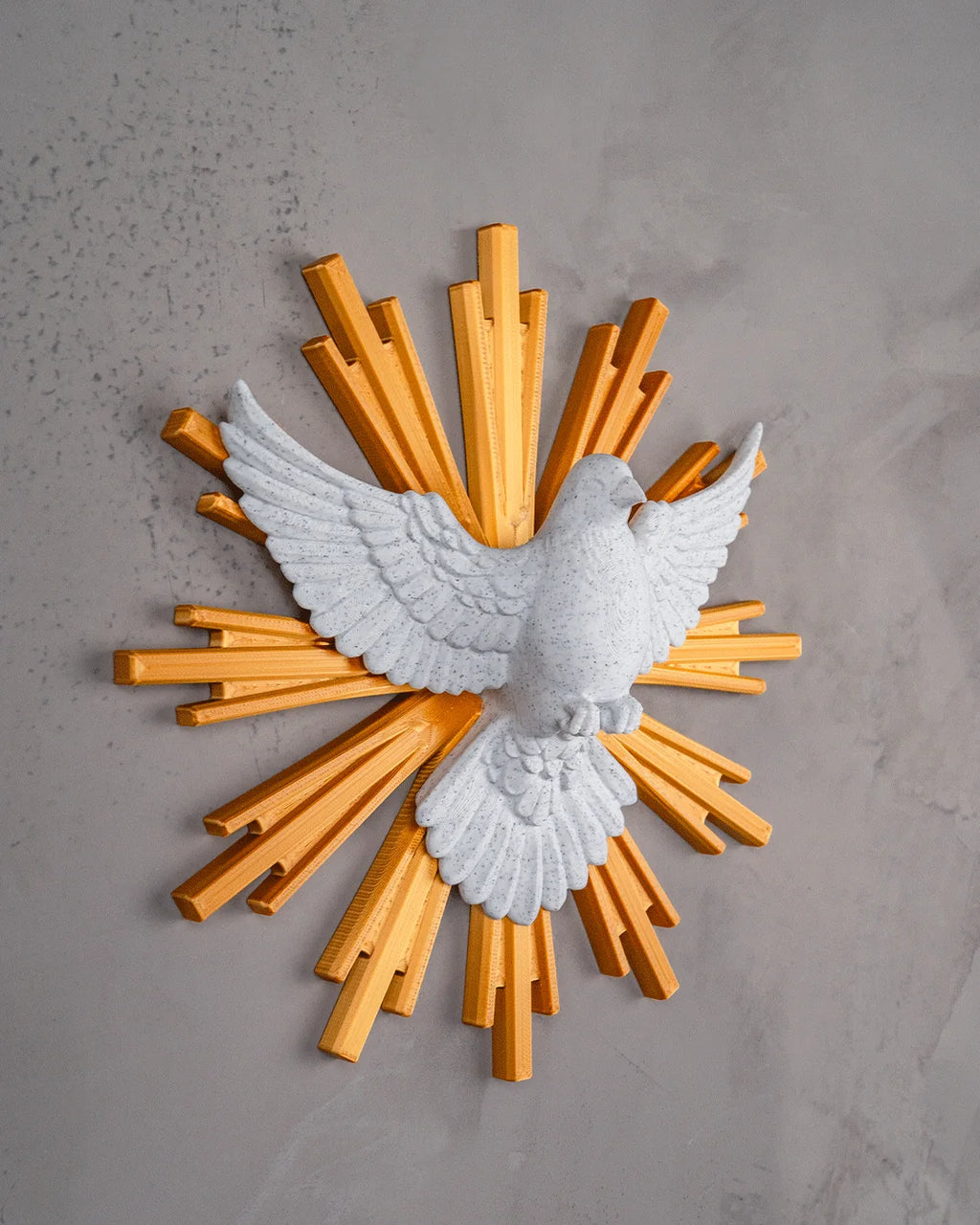 Dove of Peace wall decor in marble and gold, angled view on a light gray wall