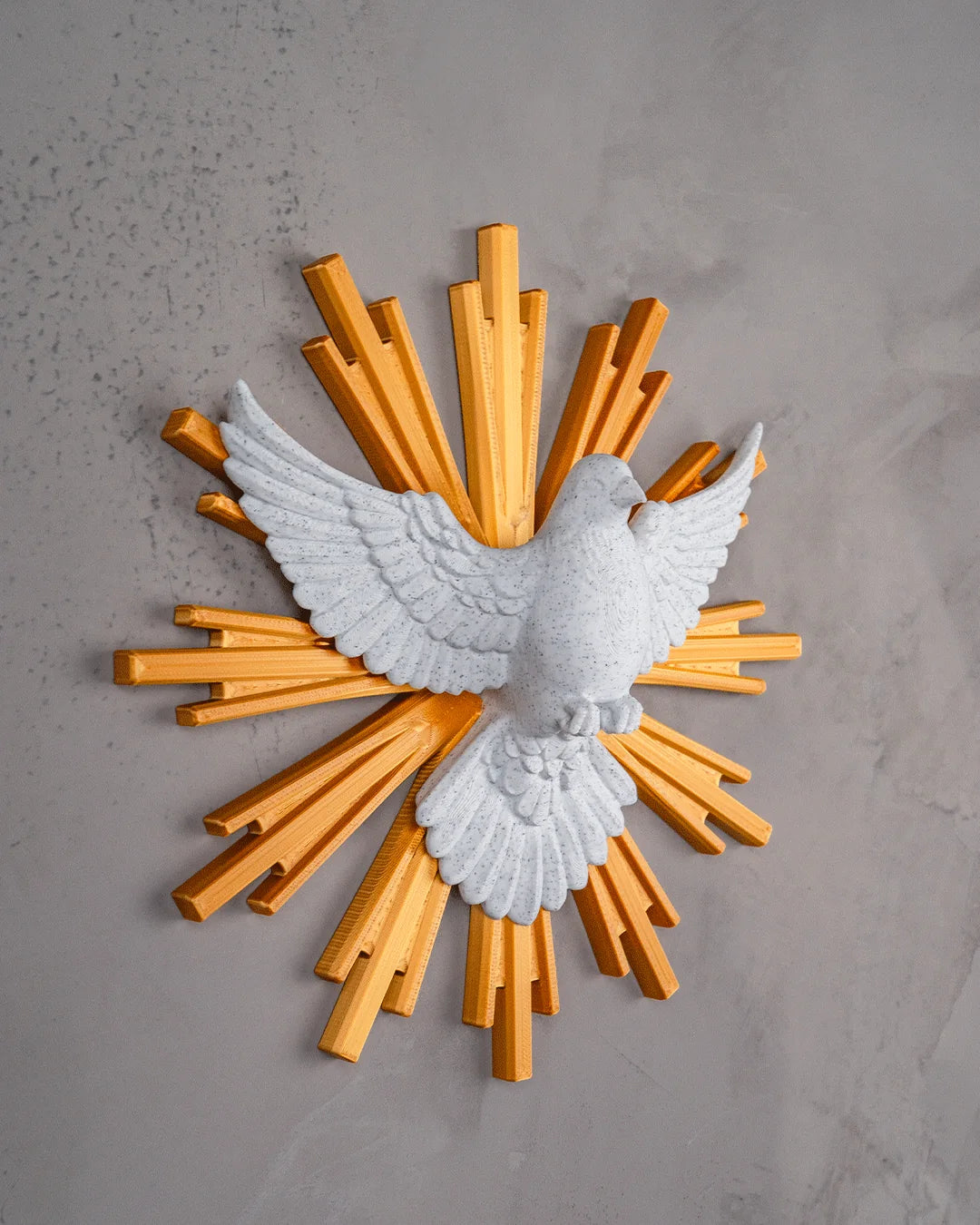 Dove of Peace wall decor in marble and gold, angled view on a light gray wall