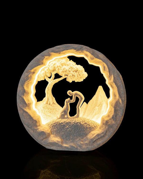 Good Boy Table Lamp illuminated from the front, showing a person greeting a dog beneath a tree