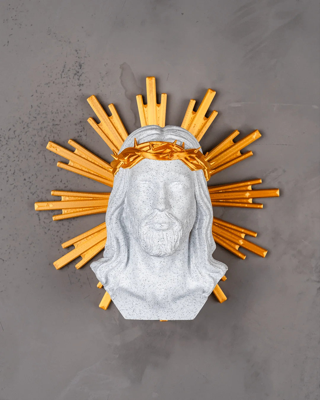 Holy Christ wall decor in marble and gold on a light gray wall