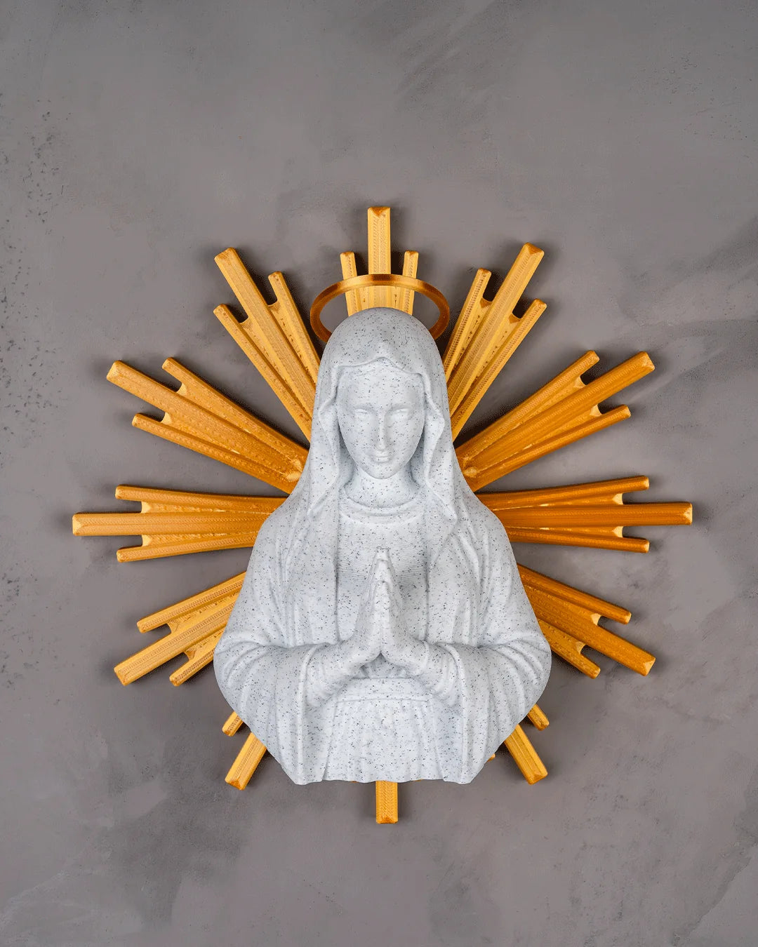 Our Lady wall decor in marble and gold on a light gray wall