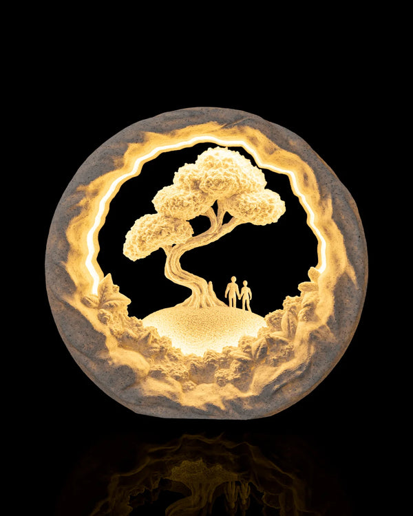 Our Journey Table Lamp illuminated from the front, showing two figures beneath a tree