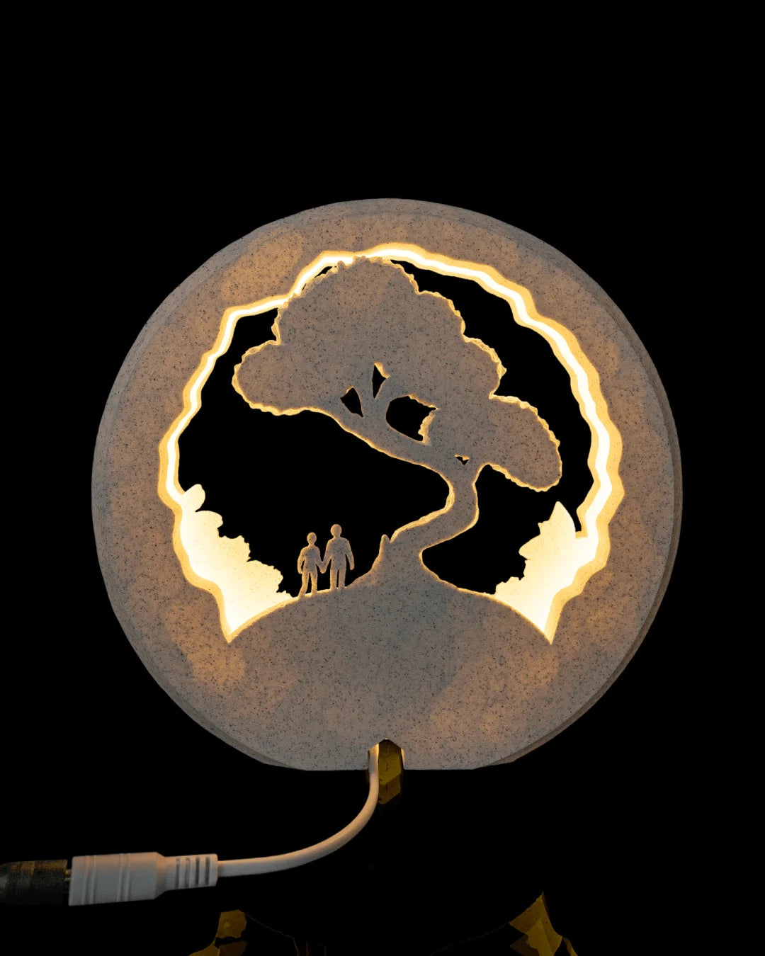 Rear view of Our Journey Table Lamp illuminated with its power connection visible