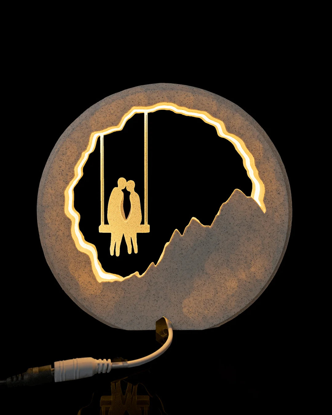 Rear view of Swing for Two Table Lamp illuminated with its power connection visible