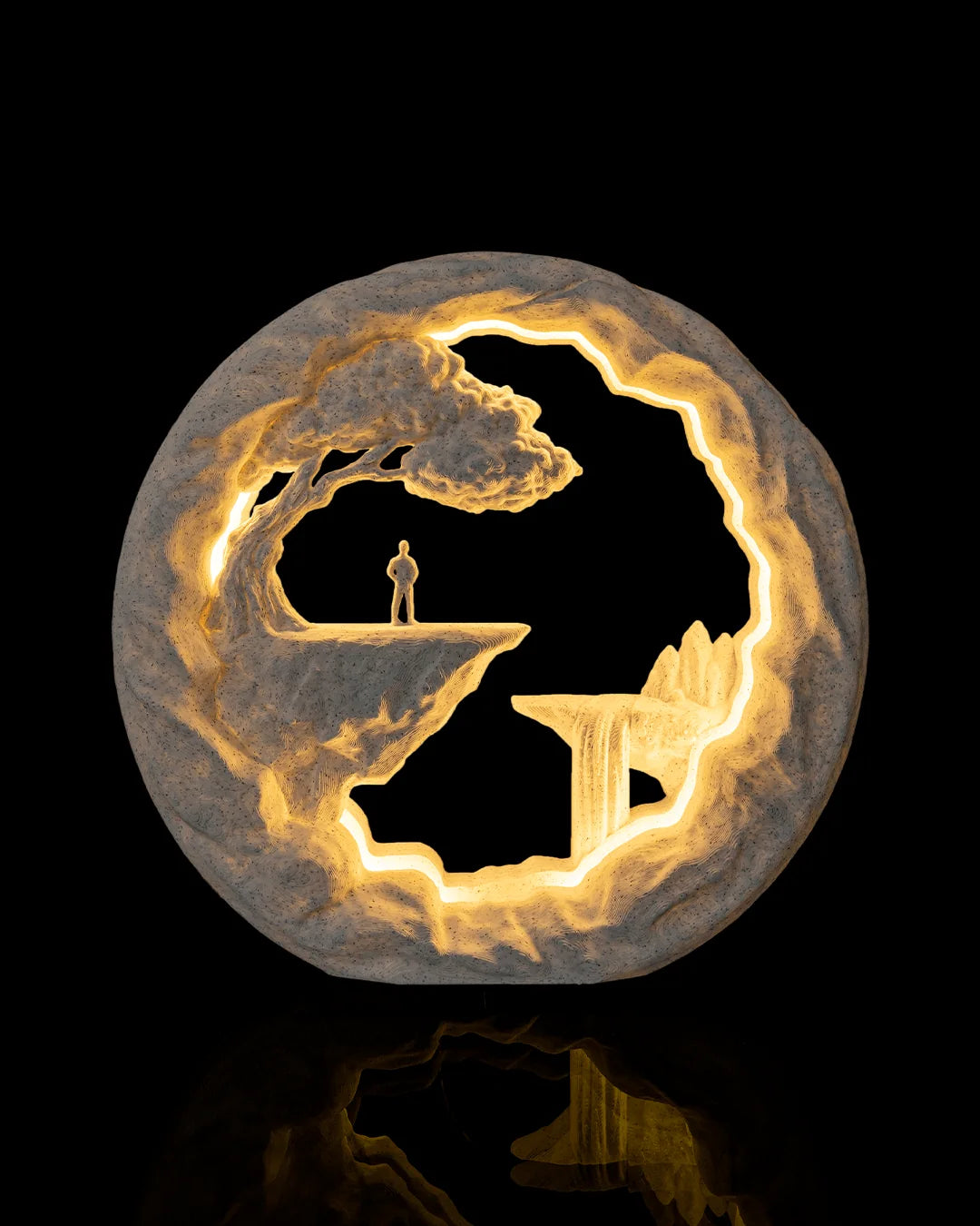 The Wanderer Table Lamp illuminated from the front, showing a lone figure above a rocky landscape